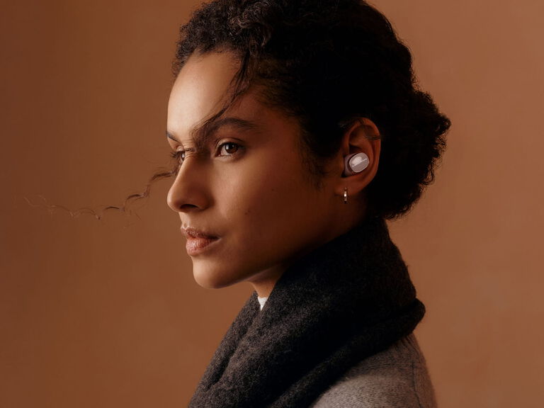 Woman facing left wearing Pi8 with brown background